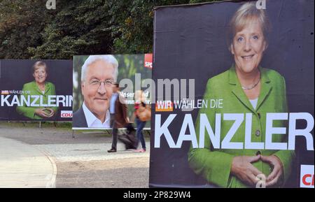 FILE - In this Sept. 14, 2009 file picture election posters of the German Christian Democratic Party CDU, with German Chancellor Angela Merkel, right and left, and of the German Social Democratic Party, SPD, with German Foreign Minister and candidate for chancellor Frank-Walter Steinmeier, are seen in Berlin. Poster at right translates to: We vote the chancellor. It's the most-avoided question in Germany's election campaign, but chances are good that Chancellor Angela Merkel could be leading another 'grand coalition' of the country's biggest parties after Sunday's vote. (AP Photo/Gero Breloer,