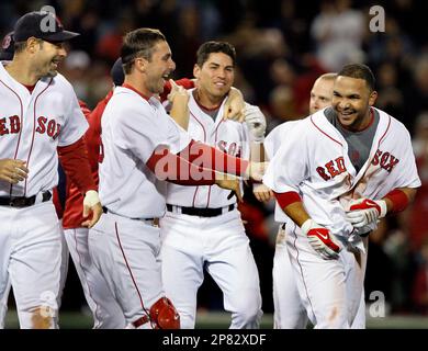 Boston Red Sox's Jason Varitek, right, pats Jed Lowrie, second from right,  after Lowrie's grand slam that brought home Varitek, George Kottaras,  second from left, and Joey Gathright, behind center, in the