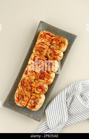 Top View Mini Loaf Bread with Pizza Topping with Sausage, Cheese, and Chilli Sauce Stock Photo