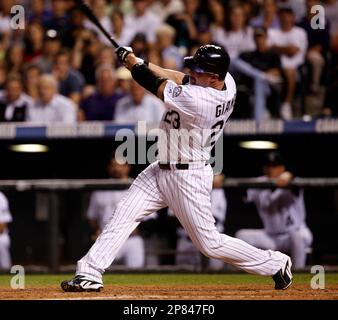 Colorado Rockies pinch hitter Jason Giambi (23) high fives teammate Todd  Helton after scoring against the Philadelphia Phillies in the eighth inning  during game four of the National League Divisional Series at