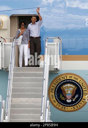 President Barack Obama escorts his daughter Malia, as Michelle