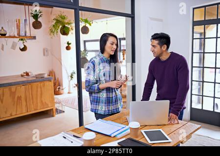Discussing some creative ideas. two young designers discussing ideas in their office. Stock Photo