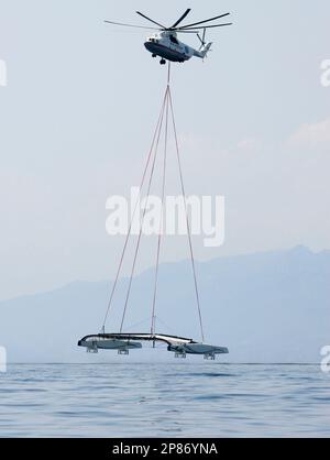 https://l450v.alamy.com/450v/2p86yna/a-russian-mi-26-heavy-lift-helicopter-lowers-the-alinghi-5-catamaran-in-the-waters-off-the-coast-of-genoa-italy-after-airlifting-it-from-lake-geneva-switzerland-friday-aug-7-2009-after-two-weeks-of-sailing-trials-on-lake-geneva-the-90-foot-catamaran-alinghi-5-will-start-sea-trails-ahead-of-their-much-heralded-duel-against-us-challenger-bmw-oracle-racing-for-the-33rd-americas-cup-which-will-be-contested-in-the-united-arab-emirates-next-february-ap-photoantonio-calanni-2p86yna.jpg