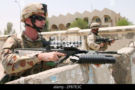 https://l450v.alamy.com/450v/2p87e3c/file-in-this-june-22-2006-file-photograph-australian-soldiers-guard-the-area-during-a-joint-street-patrol-with-iraqi-security-forces-in-samawah-south-of-baghdad-iraq-the-war-in-iraq-was-truly-an-american-only-effort-saturday-aug-1-2009-after-britain-and-australia-the-last-of-its-international-partners-pulled-out-ap-photomohammed-jalil-file-2p87e3c.jpg