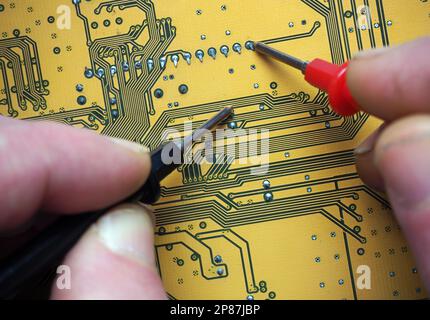 Fault detection with test probes on a digital board. Repair of an electronic device. Electronics Industry background. Stock Photo