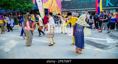 February-20-2023- Kuala Lumpur Malaysia - Prenuptial dance in the street with young people who are going to get engaged dressed in brightly colored fo Stock Photo