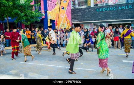 February-20-2023- Kuala Lumpur Malaysia - Prenuptial dance in the street with young people who are going to get engaged dressed in brightly colored fo Stock Photo