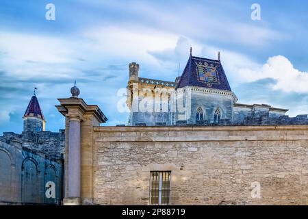 Uzes in France, old facades in the historic center, tiles roof of the castle Stock Photo