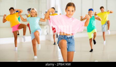 Tween girl krump dancer in choreographic studio with children Stock Photo