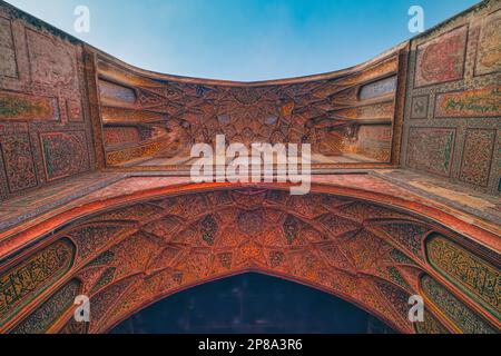 The arch niche at the entrance to the mosque overlooking the Wazir Khan Chowk is richly decorated with flower statues, and has one of Lahore’s earlies Stock Photo