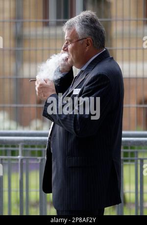 Wulf Bernotat, CEO of German power utility E.ON, smokes a cigarette before  the celebrations marking the 50th anniversary of the German Atomic Forum  (DAtF) in Berlin, Wednesday July 1, 2009. (AP Photo/Tobias