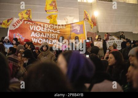 London, UK - 8 March 2023: On a cold and rainy evening, women from various backgrounds, including British, French, Iranian, Turkish, Chinese, Mexican, Afghan, and numerous other nationalities and groups, joined together in Trafalgar Square to mark International Women's Day. Credit: Sinai Noor / Alamy Live News