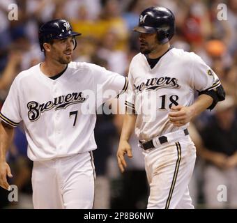 HOT START: Milwaukee's J.J. Hardy is congratulated by teammate Corey Hart  after scoring the game winning