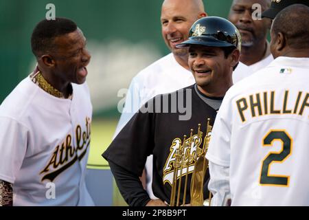 Former Oakland Athletics' Ricky Henderson swings during the ceremonial  first pitch prior to Game 1 of the Major League baseball opening series  between the Seattle Mariners and the Athletics at Tokyo Dome