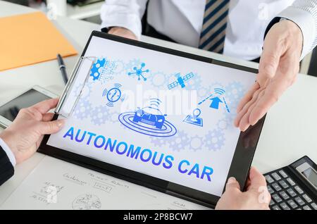 Autonomous car concept shown by a businessman Stock Photo