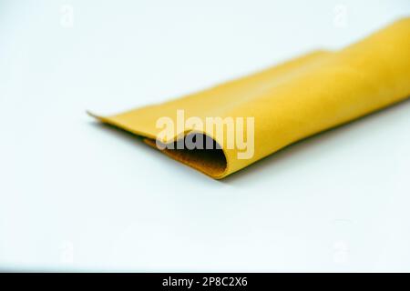 Yellow leather is folded on a white background Stock Photo