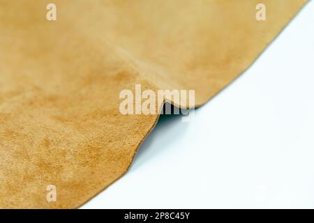 Piece of brown leather and suede cut on white background. Concept and idea of fine leather crafting, handmade, handcrafted and leather works. Backgrou Stock Photo