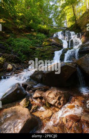 waterfall among wet rocks. fresh environment and clear water concept. summer nature scenery Stock Photo