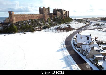 General view of Bamburgh Castle surrounded by snow in Bamburgh, Northumberland. Picture date: Thursday March 9, 2023. Stock Photo