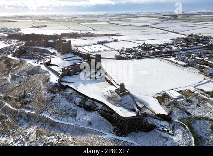 General view of Bamburgh Castle surrounded by snow in Bamburgh, Northumberland. Picture date: Thursday March 9, 2023. Stock Photo