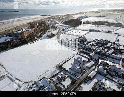 General view of Bamburgh Castle surrounded by snow in Bamburgh, Northumberland. Picture date: Thursday March 9, 2023. Stock Photo