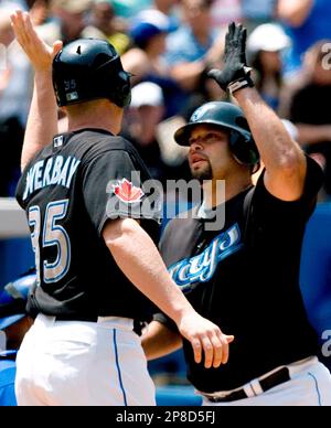 New York Yankees' Jorge Posada (20) avoided the tag from Toronto