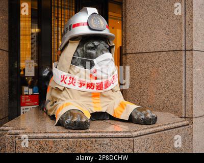 TOKYO, JAPAN - March 2, 2023: Ginza's Mitsukoshi Department Store's statue of lion wearing a fire fighter's clothes during a fire prevention campaign. Stock Photo