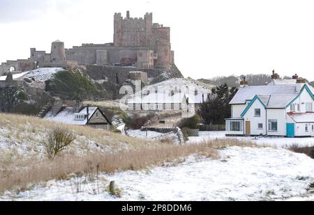 General view of Bamburgh Castle surrounded by snow in Bamburgh, Northumberland. Picture date: Thursday March 9, 2023. Stock Photo