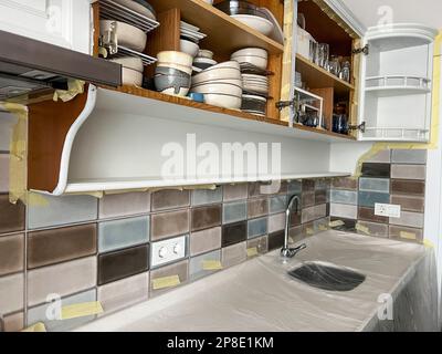 renovation, Renovating kitchen cabinets by painting them at home. diy projects. Kitchen interior with copy space. diy project at home Stock Photo