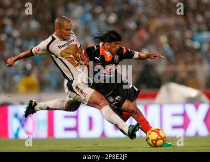Dario Veron, left, of Pumas, fights to head the ball against Guillermo  Franco of Monterrey during the first game of the Mexican soccer championship  final at the University Stadium in Mexico City