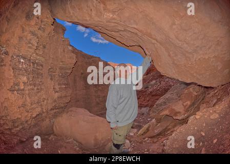 Hiker standing in a cave at Paria Canyon, Glen Canyon National Recreation Area, Arizona, USA Stock Photo