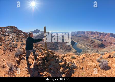 Hiker standing at the end of the Spencer Trail overlooking Lee's Ferry along the Colorado River in Glen Canyon Recreation Area of Marble Canyon, Arizona, USA Stock Photo