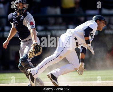 Boston Red Sox's Jason Varitek, right, pats Jed Lowrie, second from right,  after Lowrie's grand slam that brought home Varitek, George Kottaras,  second from left, and Joey Gathright, behind center, in the