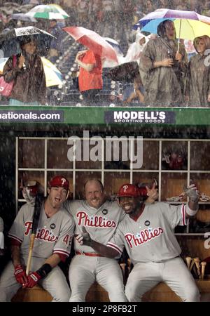 Philadelphia Phillies' Jayson Werth, second from left, Matt Stairs, second  from right, and Ryan Howard, right, sit in the dugout during a rain delay  during the sixth inning of the second game