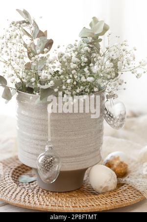 Light Easter composition with Easter eggs and gypsophila flowers. Stock Photo