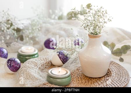 Easter composition with gypsophila flowers and Easter eggs. Stock Photo