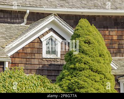 Small attic window on an old East Hampton home Stock Photo