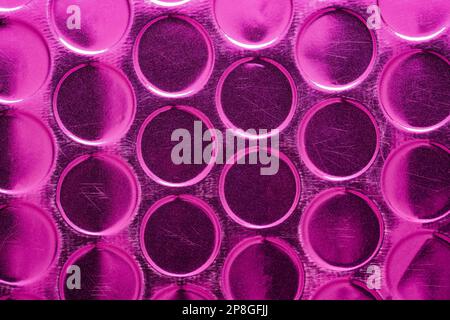 shiny metallic magenta circle scratched texture. y2k futuristic geometric abstract background Stock Photo