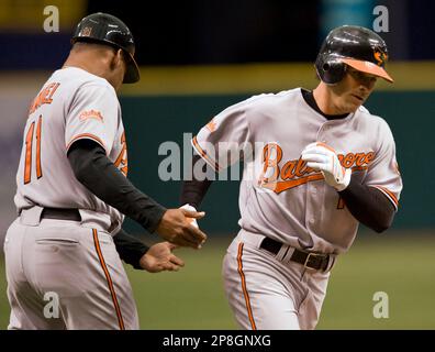 Baltimore Orioles' Brian Roberts congratulates Melvin Mora after Mora hit a  two-run homer, scoring Roberts, off Houston Astros pitcher Wandy Rodriguez  in the first inning Wednesday, June 15, 2005, in Baltimore.(AP Photo/Gail