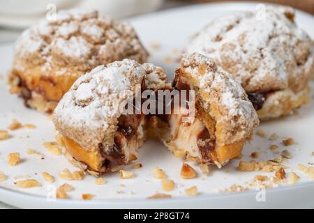 Freshly baked cream puffs. Eclair cake with cream and chocolate filling. Close up Stock Photo