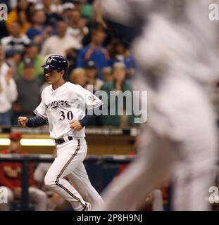 The Milwaukee Brewers' Nyjer Morgan celebrates having scored the  game-winning run on a walk-off sacrifice fly in the 10th inning against the  Los Angeles Dodgers at Miller Park in Milwaukee, Wisconsin, on