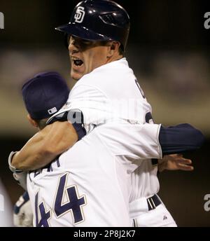 San Diego Padres' Brian Giles, center, is mobbed by teammates after his  game winning hit in the 11th inning gave the Padres a 4-3 victory over the  Pittsburgh Pirates during their baseball