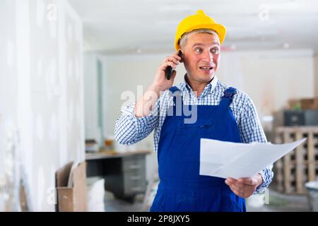Construction worker having telephone conversation Stock Photo