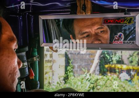 March 3, 2023, Metro Manila, National Capital Region, Philippines: Benedict, a jeepney driver, rests inside his traditional jeepney in Metro Manila. For decades, commuters have relied on jeepneys, a vibrant and iconic method of transportation in the Philippines. It is regarded as an iconic representation of Philippine transportation and has evolved into a national symbol. The first Jeepneys were converted American military jeeps that had been abandoned in the Philippines following World War II into unique public transit vehicles that could accommodate up to 20 passengers. On its decade run, th Stock Photo