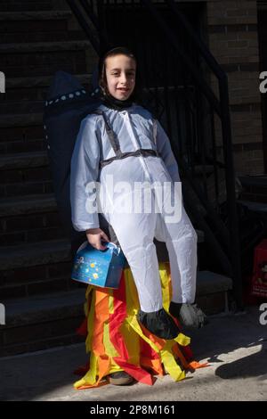 OPTICAL ILLUSION. A young hasidic Jewish boy in a clever Purim costume. In Brooklyn, New York City. Stock Photo