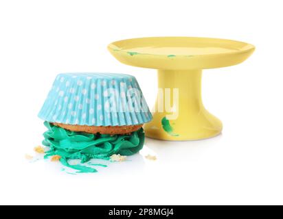 Smashed cupcake with cream near stand on white background. Troubles happen Stock Photo