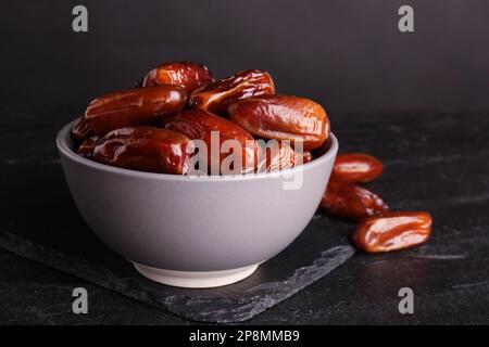 Tasty sweet dried dates on black table Stock Photo