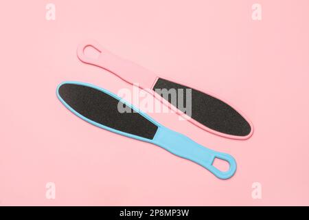 Colorful foot files on pink background, flat lay. Pedicure tools Stock Photo