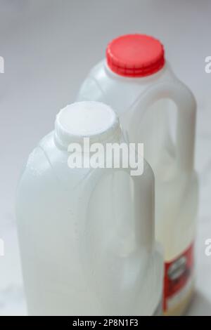 coloured milk bottle caps are changing to clear or white to help recyclability Stock Photo