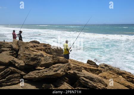 Mission Rocks, South Africa - 14 January 2023: people fishing at Mission Rocks on Isimangaliso park in South Africa Stock Photo